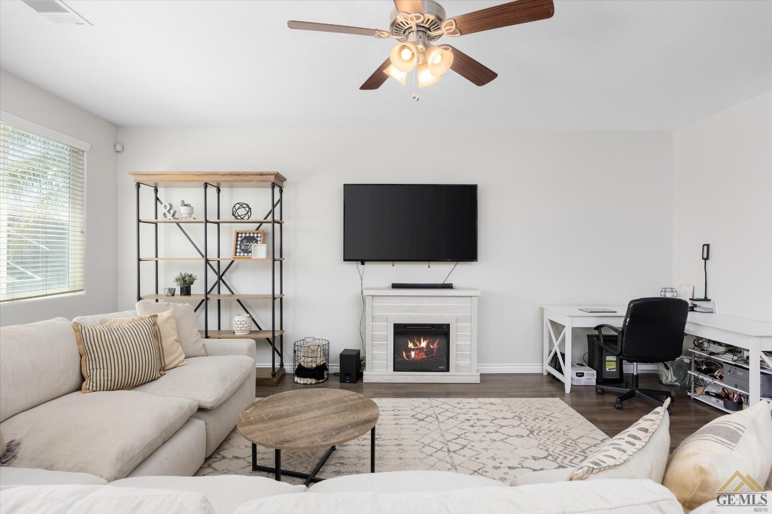 Undisclosed Address Bakersfield, CA 93314 - Photo 9 of 28 a living room with furniture a fireplace and a flat screen tv