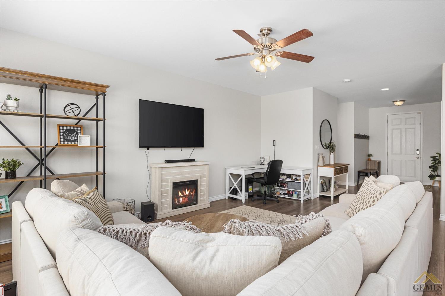Undisclosed Address Bakersfield, CA 93314 - Photo 10 of 28 a living room with furniture a fireplace and a flat screen tv