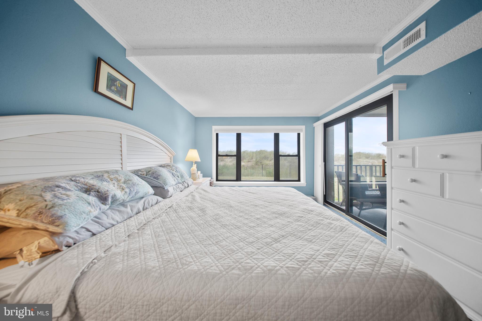 5505 Atlantic Avenue, Unit 107 Ocean City, MD 21842 - Photo 12 of 25 a bedroom with a large bed and a large window