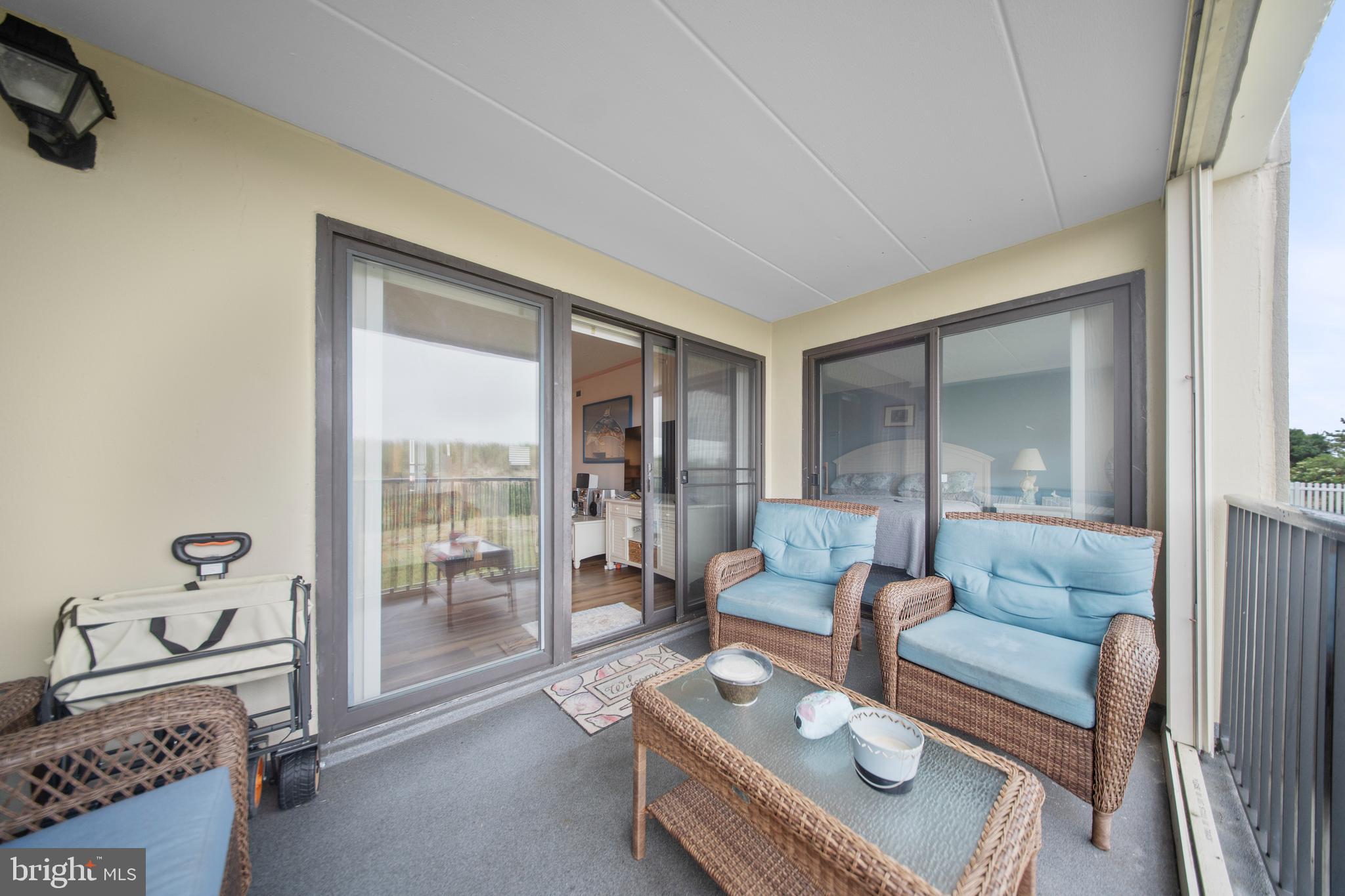 5505 Atlantic Avenue, Unit 107 Ocean City, MD 21842 - Photo 13 of 25 a living room with furniture and a floor to ceiling window