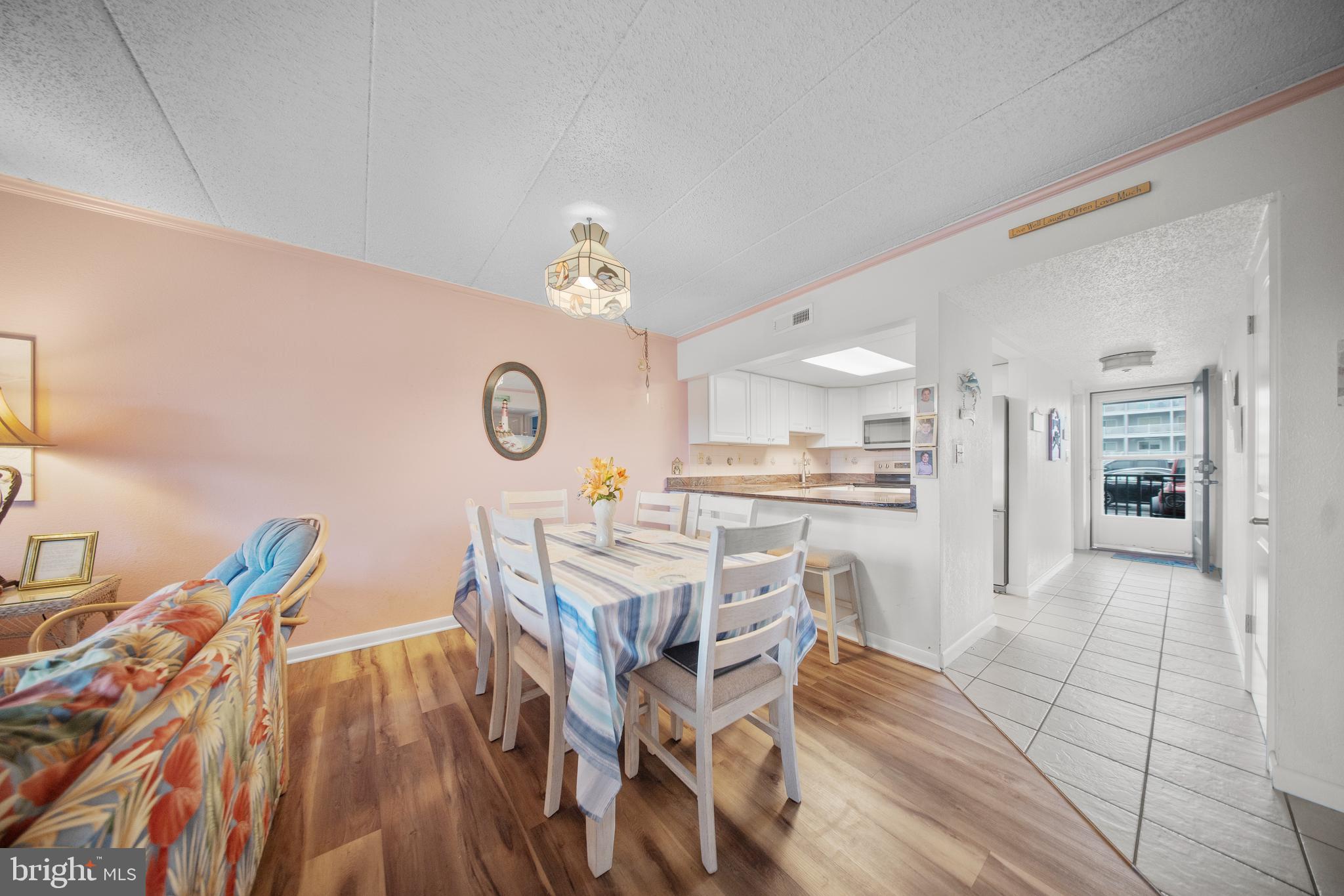 5505 Atlantic Avenue, Unit 107 Ocean City, MD 21842 - Photo 14 of 25 a view of a dining room with furniture and wooden floor
