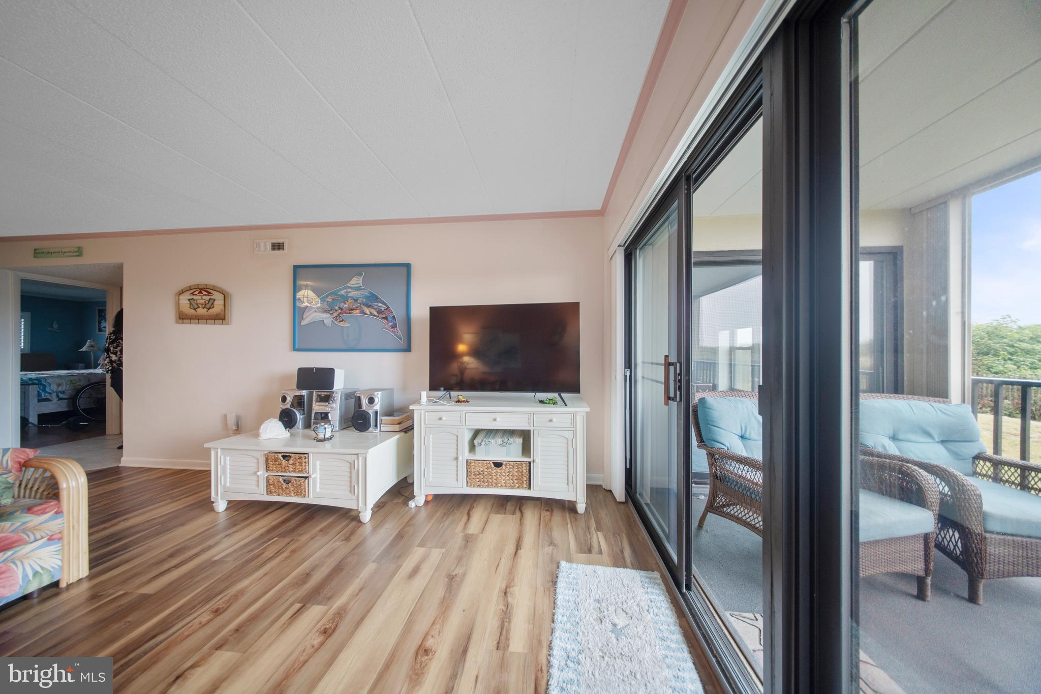 5505 Atlantic Avenue, Unit 107 Ocean City, MD 21842 - Photo 15 of 25 a living room with furniture and a flat screen tv