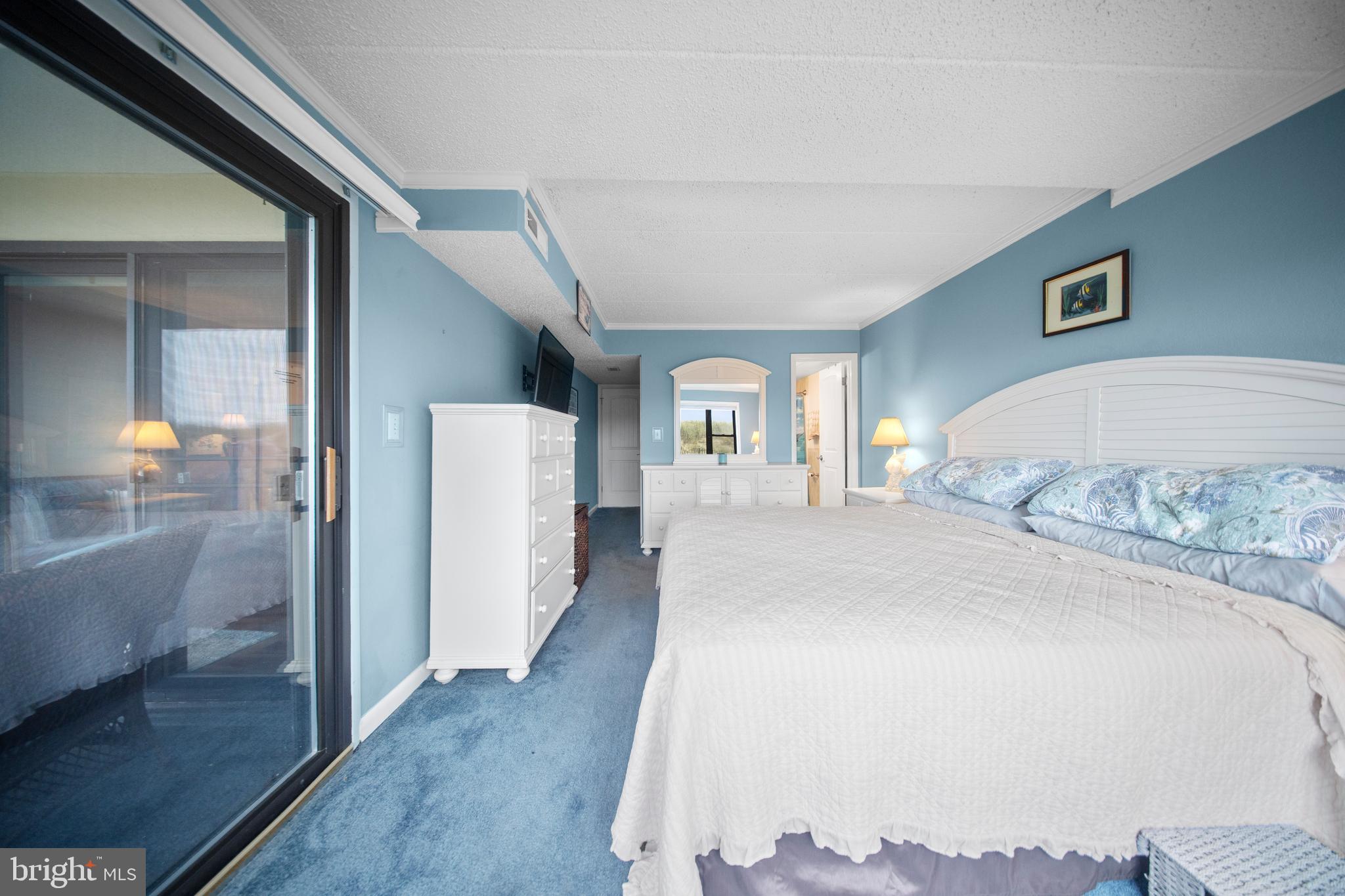 5505 Atlantic Avenue, Unit 107 Ocean City, MD 21842 - Photo 16 of 25 a spacious bedroom with a large bed and a walk in closet