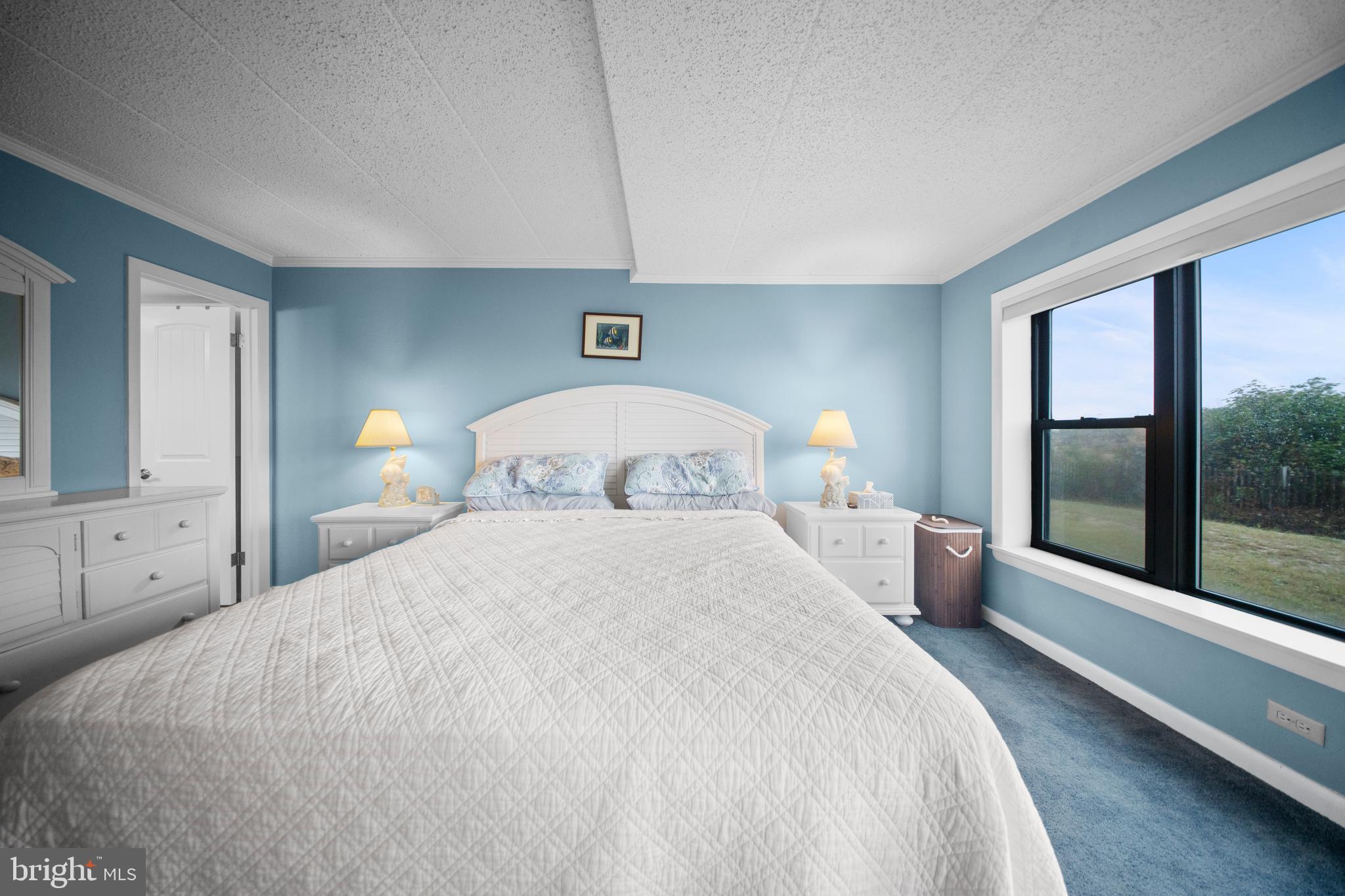 5505 Atlantic Avenue, Unit 107 Ocean City, MD 21842 - Photo 17 of 25 a bedroom with a large bed and a large window