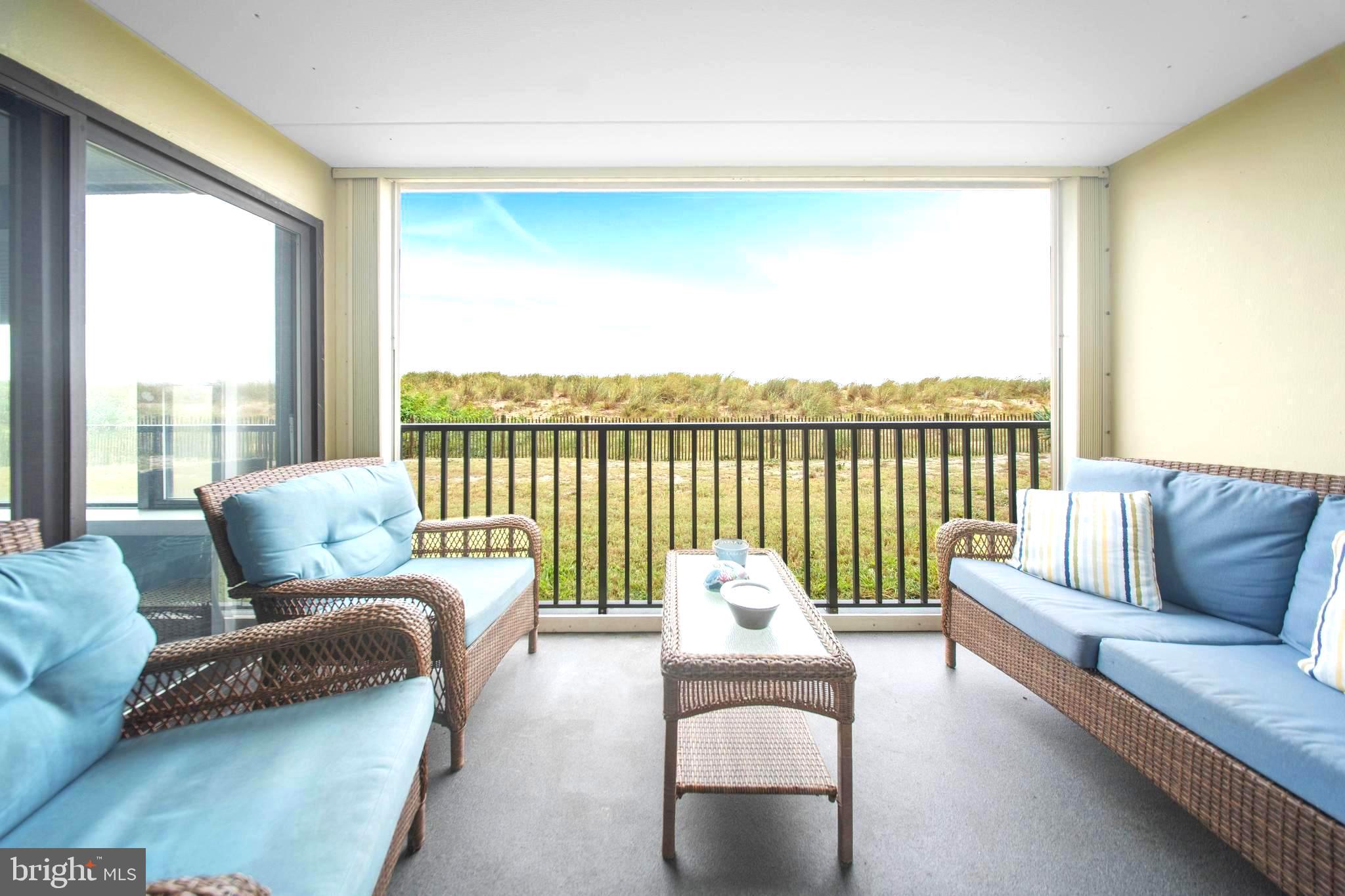 5505 Atlantic Avenue, Unit 107 Ocean City, MD 21842 - Photo 2 of 25 a living room with furniture and a large window