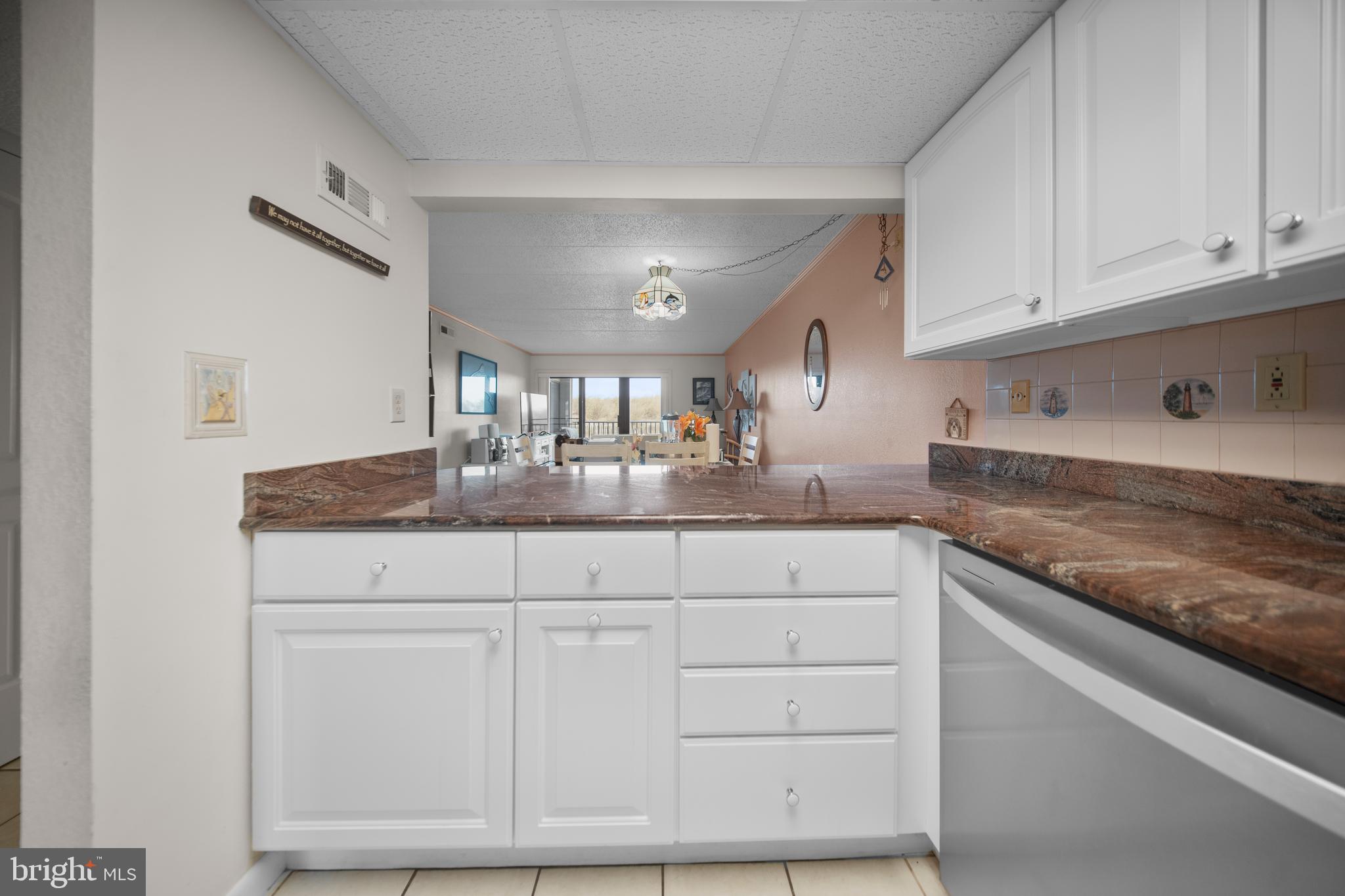 5505 Atlantic Avenue, Unit 107 Ocean City, MD 21842 - Photo 5 of 25 a kitchen with granite countertop white cabinets and a sink