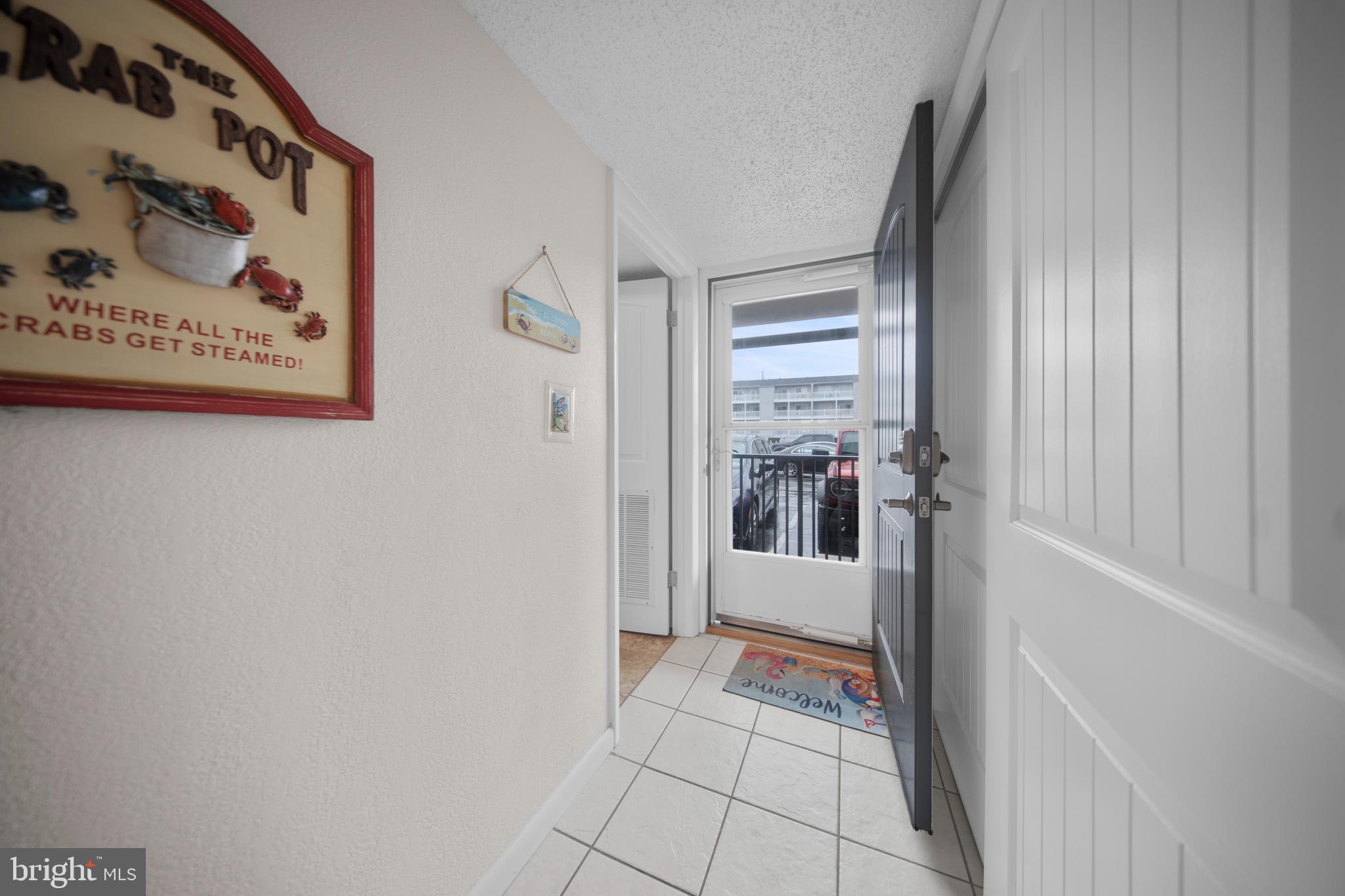 5505 Atlantic Avenue, Unit 107 Ocean City, MD 21842 - Photo 7 of 25 a view of a hallway with a outdoor space