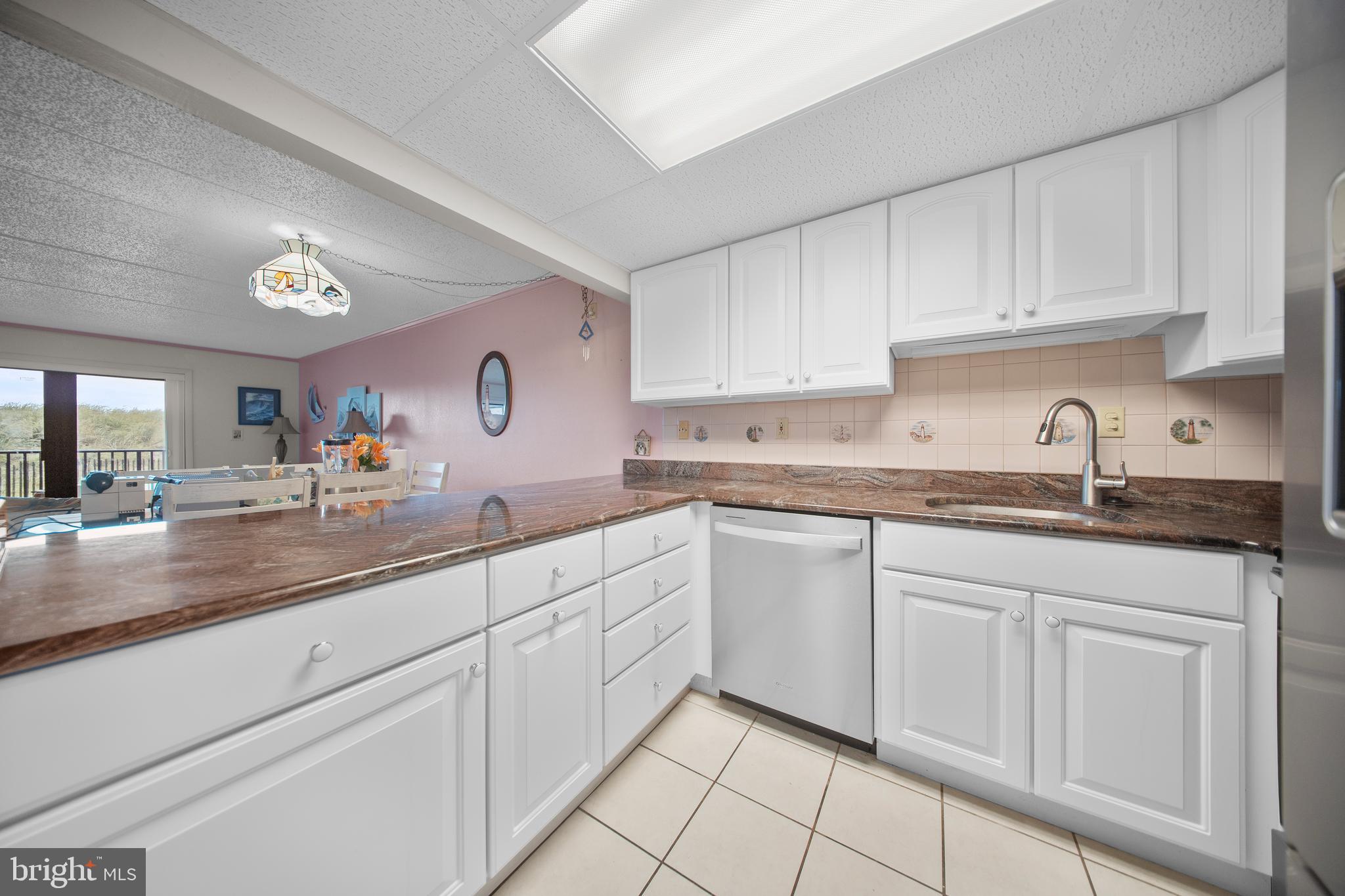 5505 Atlantic Avenue, Unit 107 Ocean City, MD 21842 - Photo 9 of 25 a kitchen with white cabinets and sink