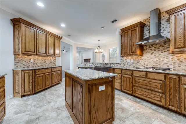 a kitchen with stainless steel appliances granite countertop a refrigerator and a stove