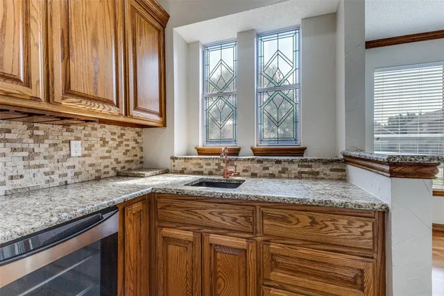 a kitchen with stainless steel appliances granite countertop wooden cabinets and a granite counter tops