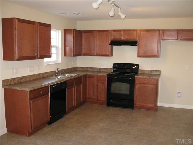 2708 Manthorp Terrace Raleigh, NC 27610 - Photo 5 of 19 a kitchen with a sink and a stove
