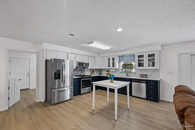 a view of a kitchen with washer and dryer