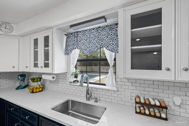 a kitchen with stainless steel appliances granite countertop a refrigerator sink and stove