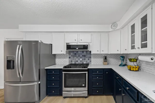 a spacious bathroom with a granite countertop sink and a window