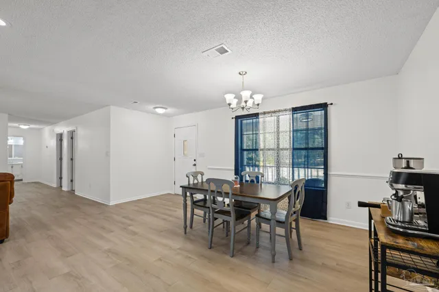a view of a dining room with furniture and window