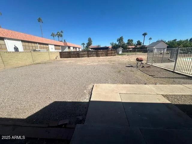 a view of a house with a yard and potted plants