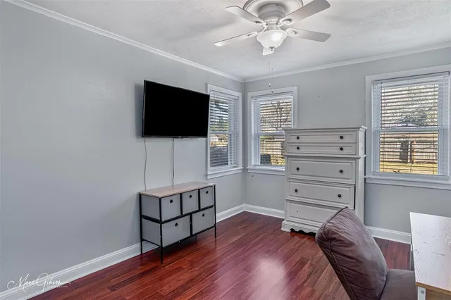 a bedroom with furniture and a flat screen tv