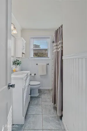 a spacious bathroom with a toilet sink and shower