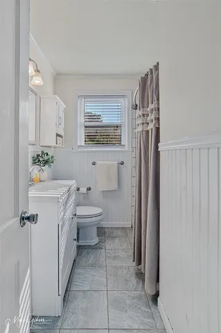 a spacious bathroom with a toilet sink and shower
