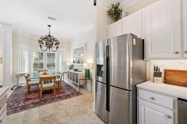 a living room with furniture a rug a window and a flat screen tv