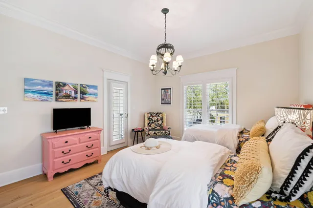 a dining room with furniture and a floor to ceiling window