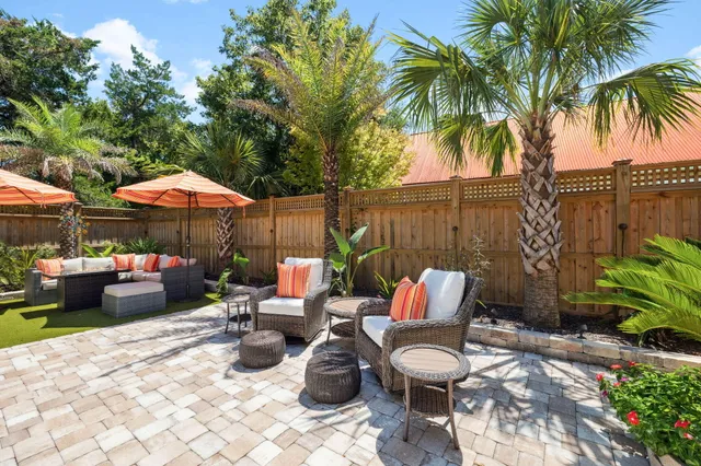 a view of a house with backyard and sitting area