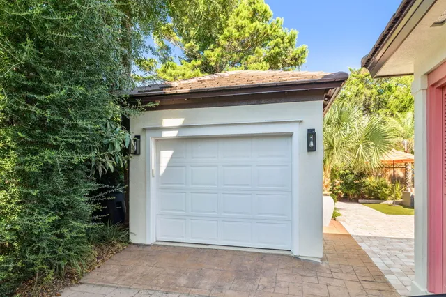 a view of a street with lots of trees and plants