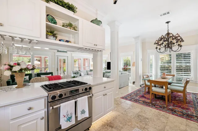 a kitchen with stainless steel appliances granite countertop a stove top oven a sink a counter space and cabinets