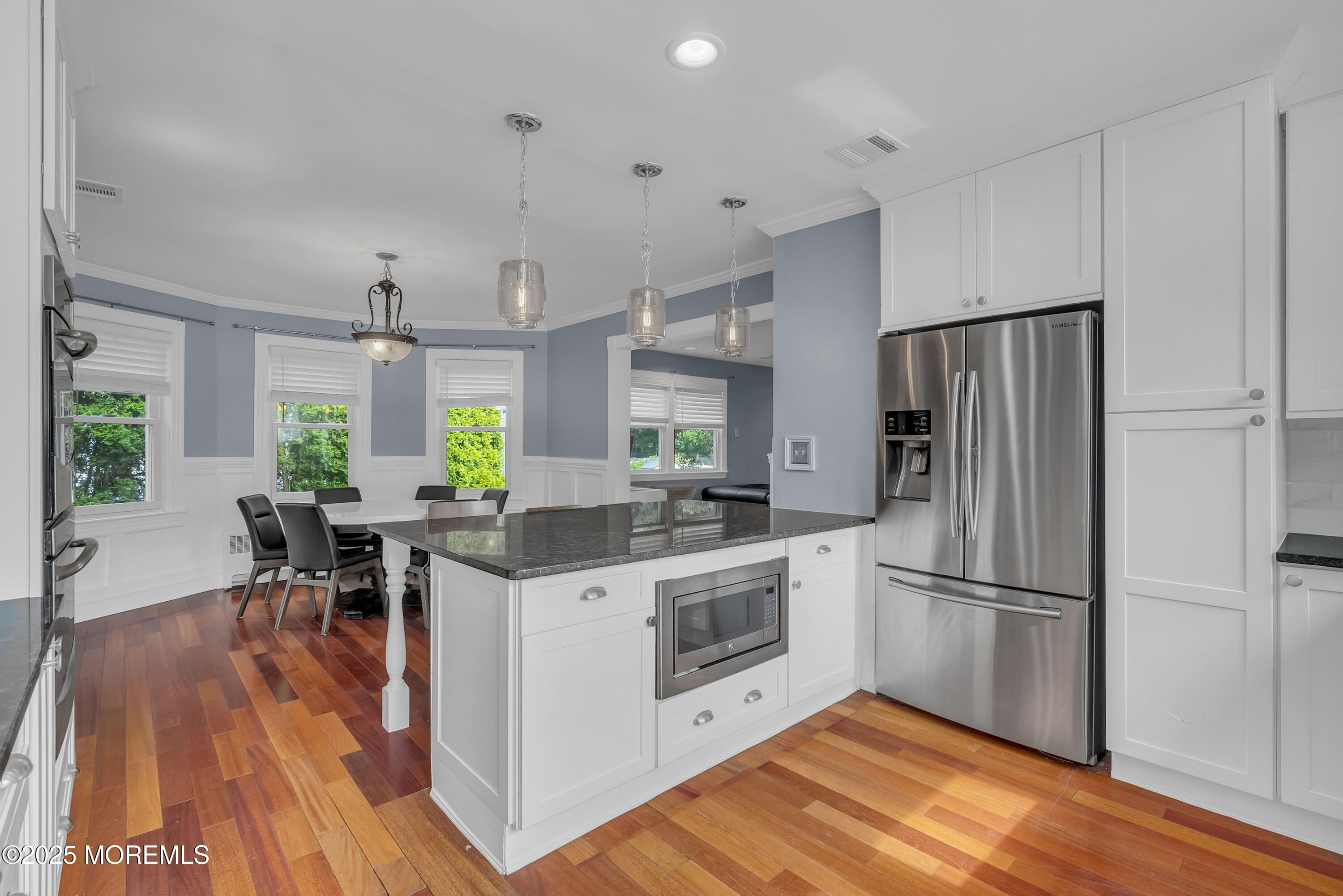 308 Monmouth Road West Long Branch, NJ 07764 - Photo 13 of 32 a kitchen with stainless steel appliances granite countertop a refrigerator a stove a sink dishwasher and a dining table with wooden floor