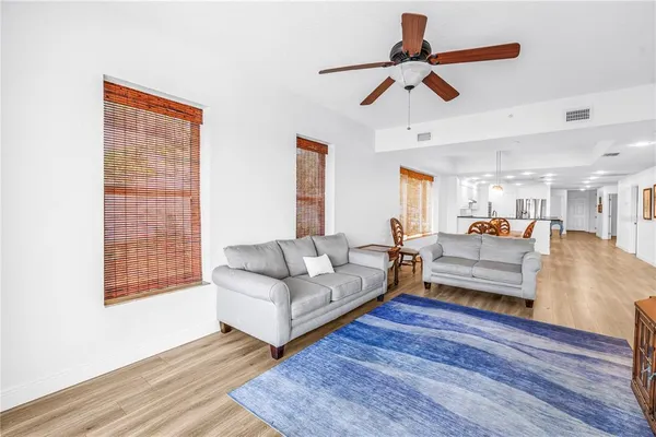 a living room with furniture and a wooden floor