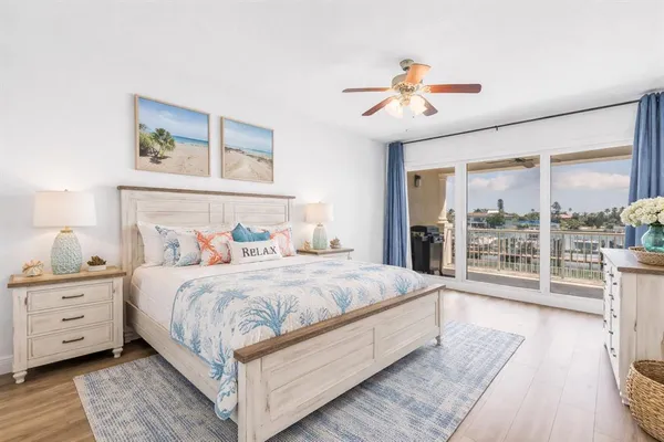 a bedroom with a large bed and a large window