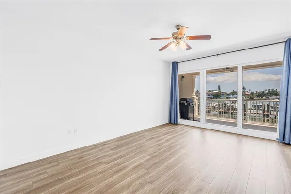 a view of a room with wooden floor fan and a window