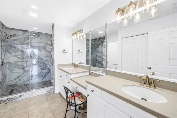 a bathroom with a sink double vanity and shower