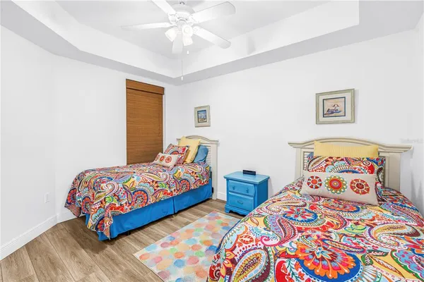 a bedroom with bed and wooden floor