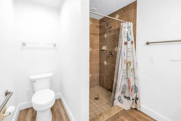 a bathroom with a toilet and a shower
