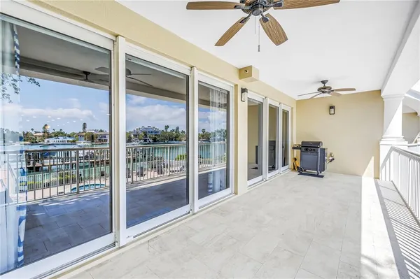 a room with sliding door and a ceiling fan