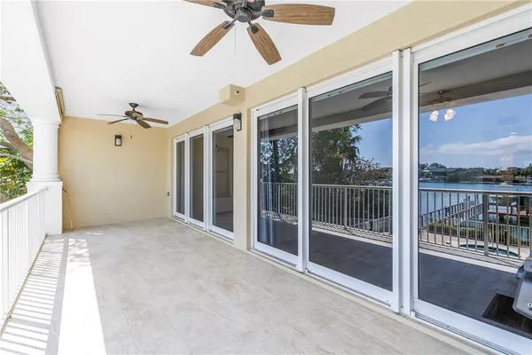 a view of a porch with a floor to ceiling window and wooden floor