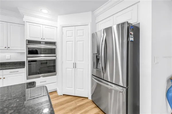 a kitchen with stainless steel appliances a refrigerator and microwave