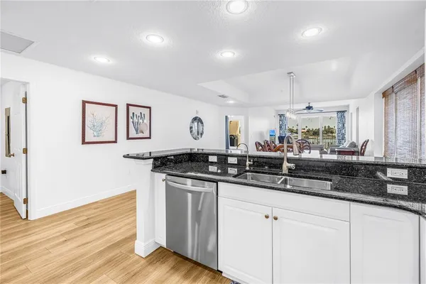 a kitchen with stainless steel appliances granite countertop a sink and cabinets