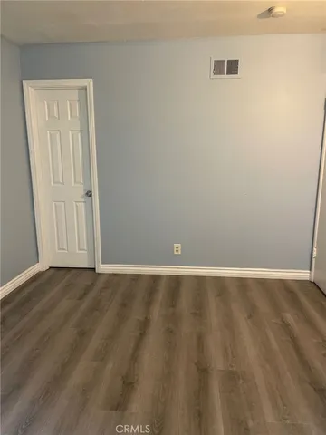 an empty room with wooden floor