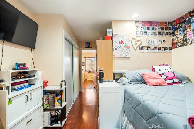 a bedroom with furniture and a flat screen tv
