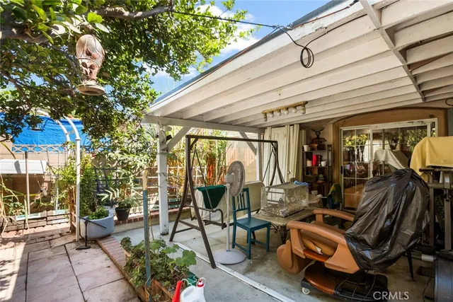a view of a patio with table and chairs and potted plants