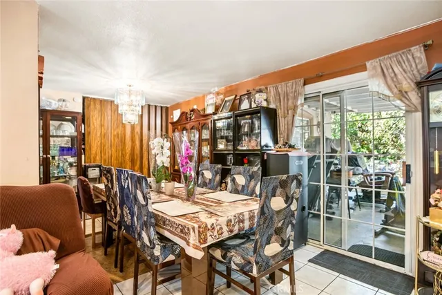 a dining room with furniture and a floor to ceiling window