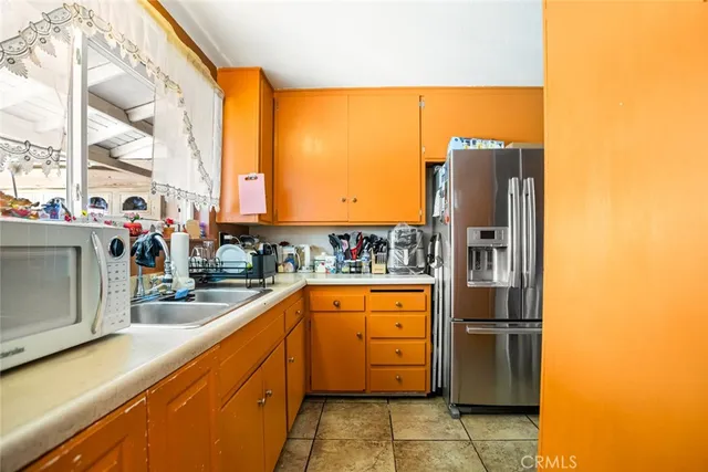 a kitchen with stainless steel appliances granite countertop a refrigerator and a stove