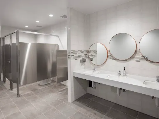 a bathroom with a double vanity sink and a mirror