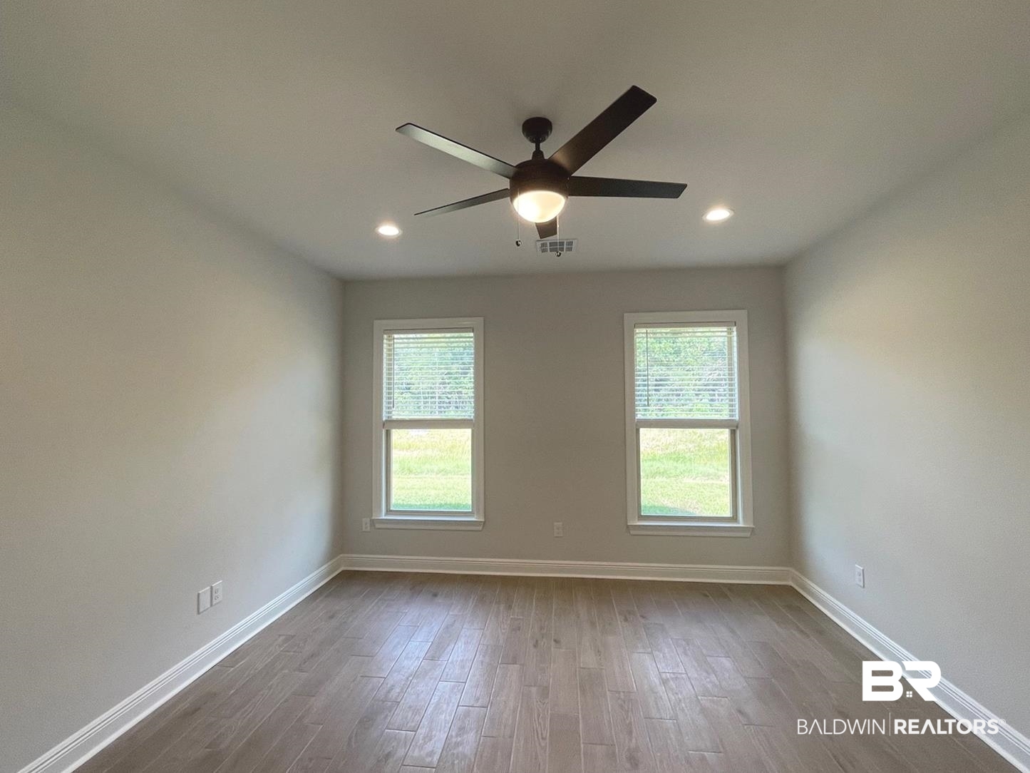 1424 Fenton Circle Foley, AL 36535 - Photo 9 of 20 Unfurnished room featuring a wealth of natural light, hardwood / wood-style floors, and ceiling fan