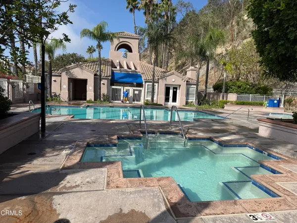 a backyard of a house with lots of green space and lake view