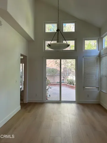 an empty room with windows and mountain view