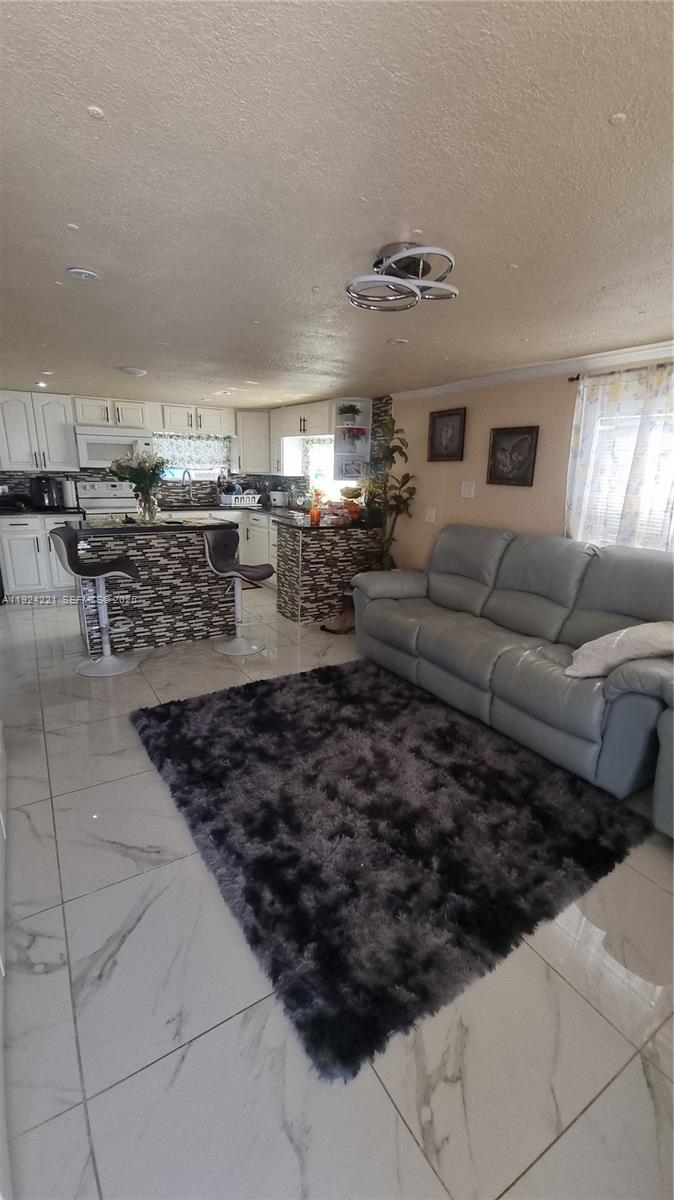 3170 Southwest 8th Street Miami, FL 33135 - Photo 2 of 33 a living room with lots of chairs and a couch