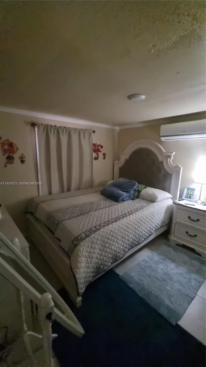 3170 Southwest 8th Street Miami, FL 33135 - Photo 21 of 33 a bedroom with a bed and window